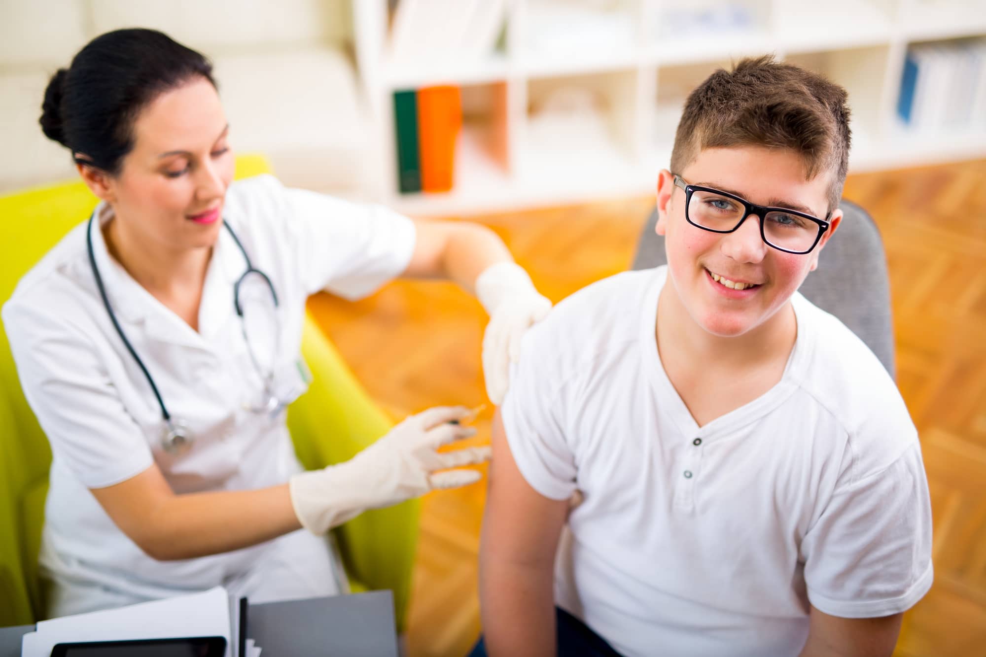 Teenage boy getting vaccination in his arm
